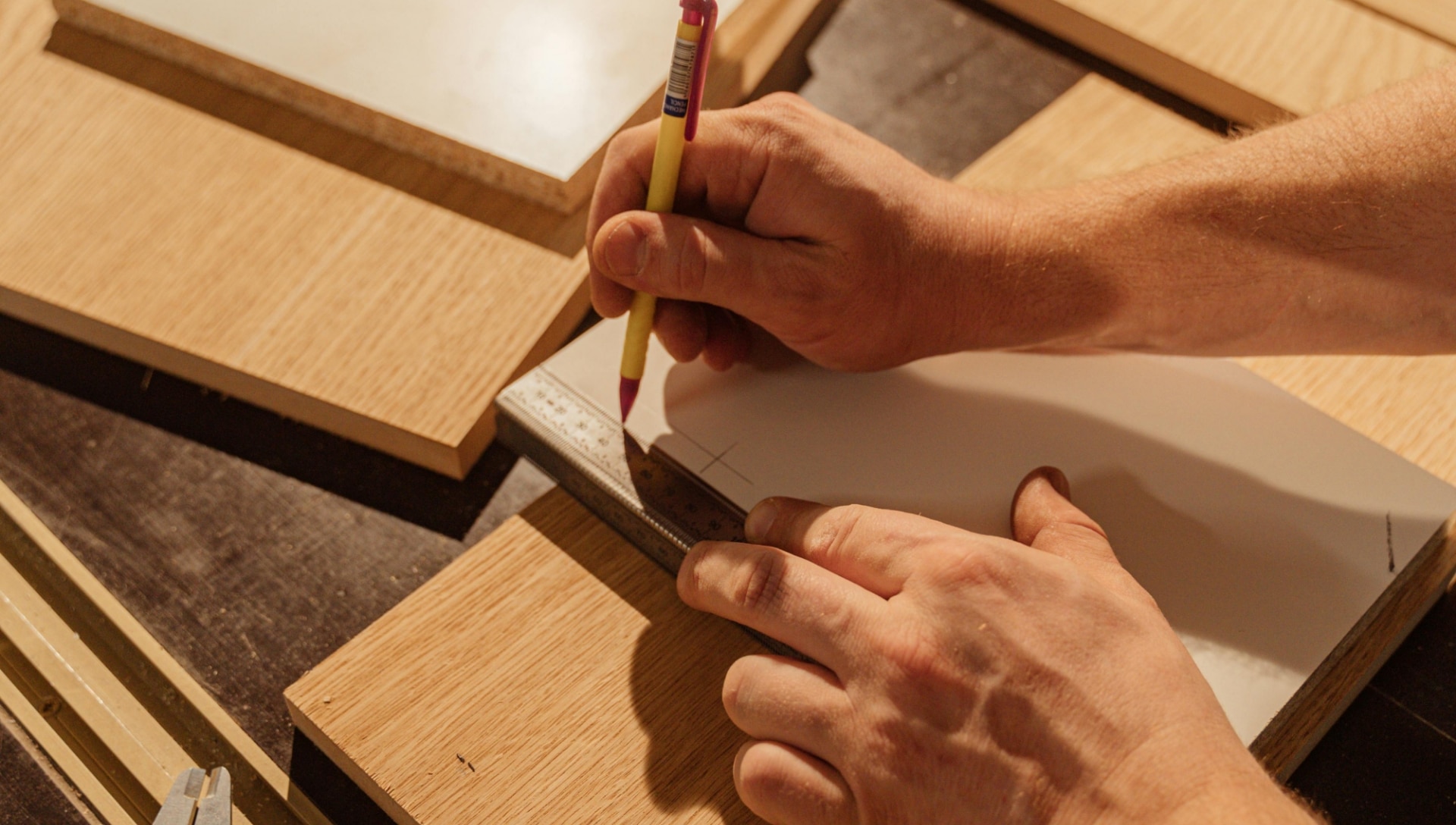 hands measuring out a wood template