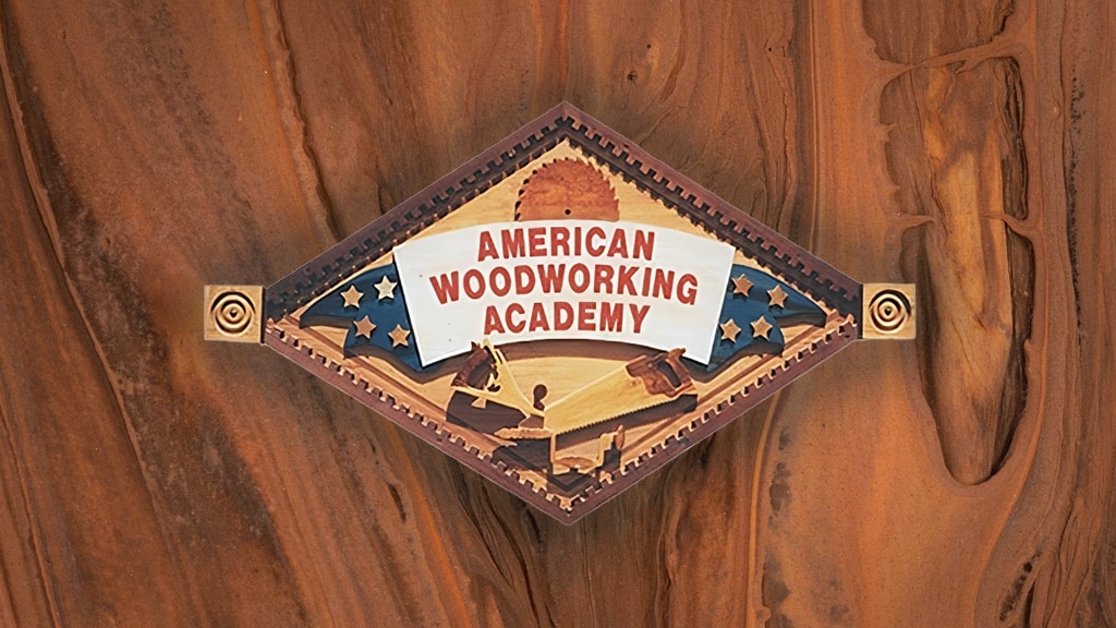 american woodworking academy logo on wood