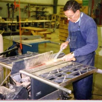 student cutting wood on a table saw in the advanced cabinetry class