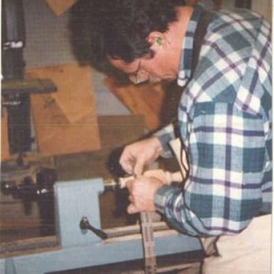 sanding a table leg on a lathe